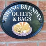 Among Brenda's Quilts & Bags Business Sign Crafted by Village Metalsmiths